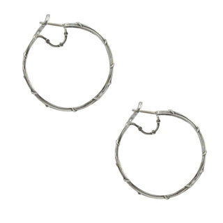 Karen Karch silver hoop earrings with a double vine design, intricately detailed and aligned with a support bar side view on white bacground.