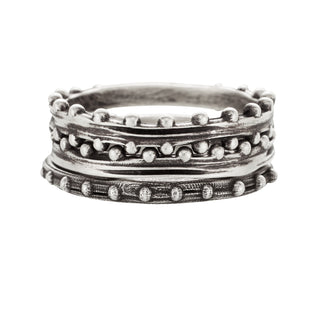 A set of 3 Karen Karch silver bands with repeating ball details on one side, both sides, and on the top stacked on a white background.