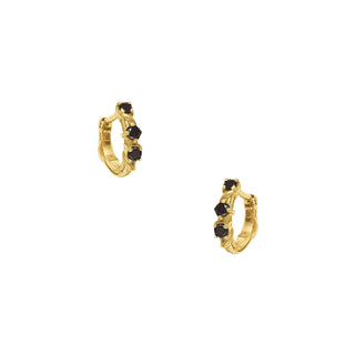 Karen Karch Yellow Gold huggie hoop earrings with black diamonds on a white background