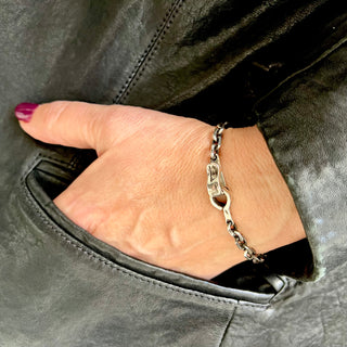 Karen Karch Hooked Silver 5mm Diamond Cut Cable chain bracelet with Handmade Weathered Spring Hook Clasp on a wrist.