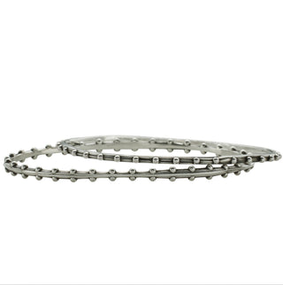 A pair of Karen Karch silver oval bangles with repeating ball details, displaying a weathered texture and irregular edges.