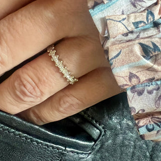 Karen Karch Jaipur Swing 18kw Diamond Half Eternity Ring with Ball details on both sides of band on a hand.