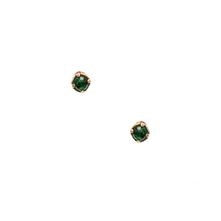 Pair of Karen Karch green emerald gemstone studs in a rose gold claw setting on a white background.