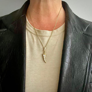 KAREN KARCH Diamond-studded Horn Amulet on Diamond Bail Yellow Gold on chain on person in leather jacket