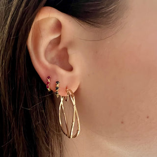 Karen Karch 1.5 inch 14k yellow gold double hoop earrings with twining vines on ear styled with Ruby and black diamond vine sleeper hoops