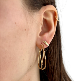 Karen Karch 1.5 inch 14k yellow gold double hoop earrings with twining vines on ear styled with wing stud