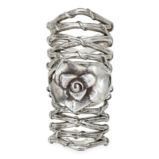 Karen Karch Gabrielle Rose silver knuckle ring with a rosebud that sits over the knuckle that connects to two Gladiator Vine Bands extending the length of the finger on white background.