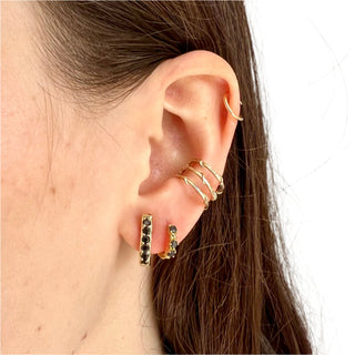 Karen Karch Yellow Gold huggie hoop earrings with black diamonds on the ear styled with larger Black diamond hoop and ear cuff