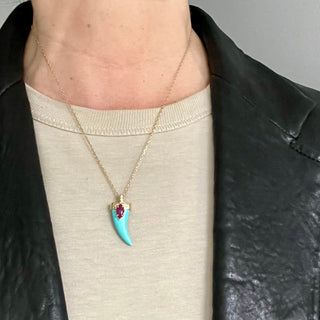 Karen Karch Draped Lucky Horn Amulet 18k Yellow Gold Ruby Turquoise Moonstone Amulet on chain styled on person in leather jacket