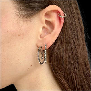 Karen Karch Jaipur Evermore pair of 1-inch silver hoop earrings with a repeating ball detail and drops styled on ear