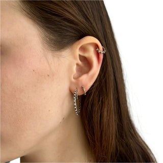 Karen Karch Jaipur Evermore pair of 1-inch silver hoop earrings with a repeating ball detail on the ear styled with Jaipur Evermore huggie hoops