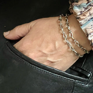 Karen karch Jaipur Infinite sterling silver handmade chain with figure eight shaped links detailed with 4 balls at the center, shown wrapped around the wrist.