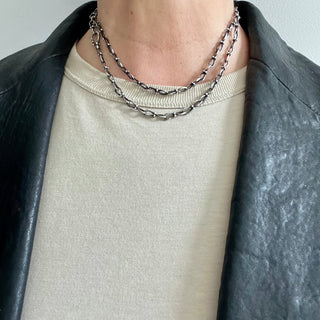 Karen karch Jaipur Infinite sterling silver handmade chain with figure eight shaped links detailed with 4 balls at the center, shown doubled on neck