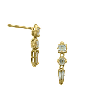 A pair of Karen Karch dangling diamond earrings with a line of three distinct shapes, each with a central diamond, set in gold claw settings, one front and one side view