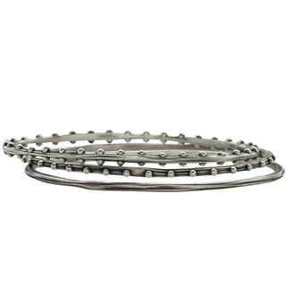 Set of 3 unique oval shape silver bangles by Karen Karch on a white background