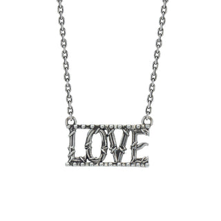 A silver necklace with the word 'LOVE' crafted in textured metal with vine details, connected to a border with small balls, on a diamond-cut cable chain.
