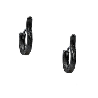 A pair of blackened silver cuff hoop earrings with a textured surface.