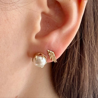 Karen Karch by Deme Wolfe Mystical Crown 10k yellow gold stud earrings featuring lustrous white freshwater pearls styled with mini wing stud on ear, view 2.