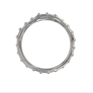 A Karen Karch platinum band with a textured surface and ball embellishments along the circumference, top view, on a white background.