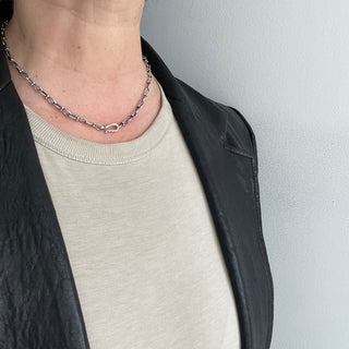 Karen karch Jaipur Infinite sterling silver handmade chain with figure eight shaped links detailed with 4 balls at the center, with hook clasp shown center n neck