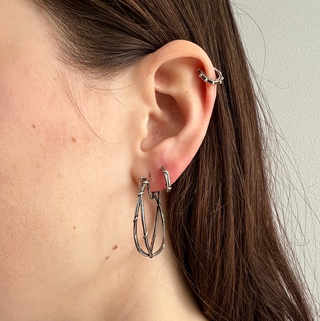 A sterling silver sleeper hoop earrings with vine details, on the ear styled with Larger Double Vine Hoops