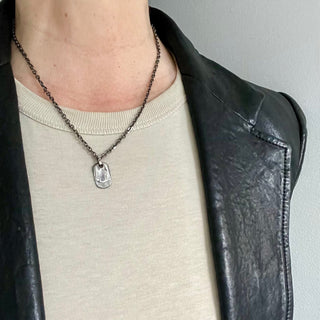 Karen Karch Unearthed Layered Tags on chain in silver on model in leather jacket
