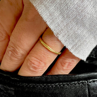 Karen Karch Willow Weathered Irregular edge 18k yellow gold slender band on hand.