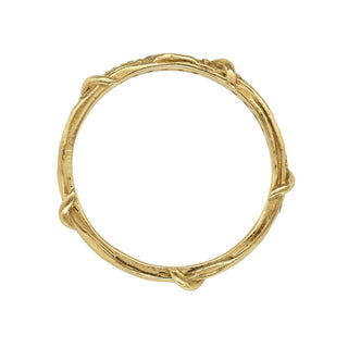 A weathered band in 18k yellow gold is detailed with organic twining vines is studded with colorless brilliant cut diamonds on the top half, top view,  shown on a white background.