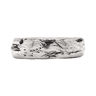 A Karen Karch silver domed weathered band with an irregular rounded edge on white background.