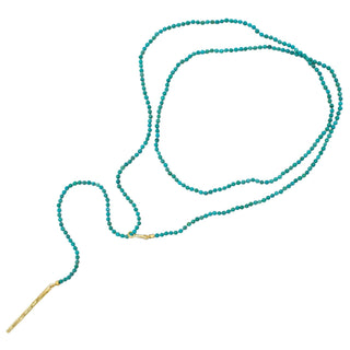 A turquoise and gold beaded lariat necklace with a loop and pull-through bar closure by Karen Karch