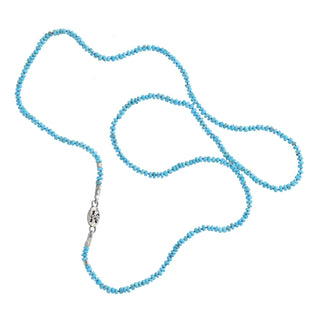 A delicate beaded necklace by Karen Karch made of turquoise faceted beads, featuring a logo silver-tag displayed on a clean white background