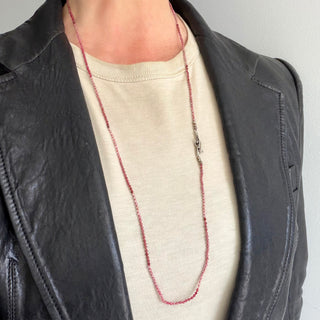 Karen Karch Silver VINE TATTOO HOOKED Clasp close up  on Bead LITHE necklace in pink to red shaded 2mm faceted round beads shown long and loose on a neck.
