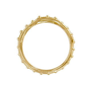 A Karen Karch 18k yellow gold band  with a textured surface and ball embellishments along the circumference, top view, on a white background.