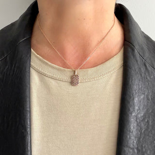 Karen Karch Rose Gold Dog Tag studded with black diamonds on 16" 18k rose gold chain on a neck.