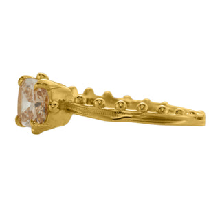 An 18k yellow gold ring by Karen Karch with a cushion-cut champagne diamond set in a four-claw demi-bezel setting, featuring a weathered texture band with ball details, side view, on a white background.