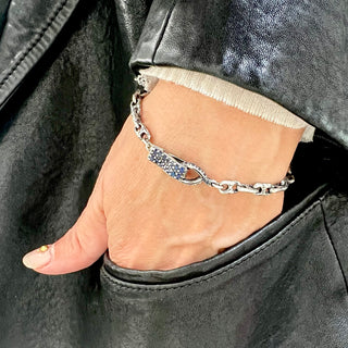 Karen Karch Silver Handmade Chain Weathered 2-Hole Link Bracelet with Blue Sapphire Studded Spring Hook Clasp on a wrist.