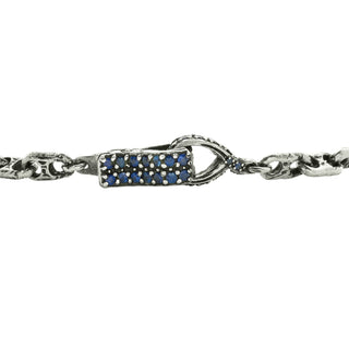 Close up of Karen Karch Blue Sapphire Studded Spring Hook Clasp on Silver Handmade Chain Weathered 2-Hole Link Bracelet.