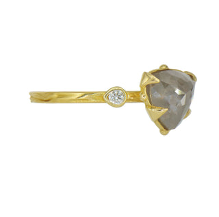 Side view of a Karen Karch 18k Dark Grey Trilliion Diamond held by 4 claws with a colorless diamond on each side on a weathered gold band.