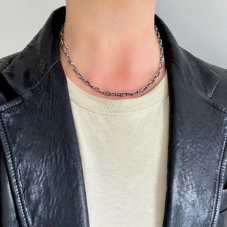 Karen Karch Jaipur Infinite sterling silver handmade chain with figure eight shaped links detailed with 4 balls at the center, worn on the neck.