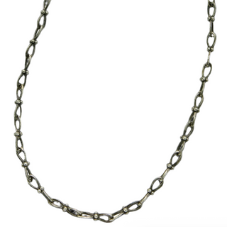 Karen karch Jaipur Infinite sterling silver handmade chain with figure eight shaped links detailed with 4 balls at the center close up on white.