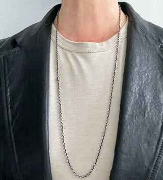 Karen Karch Long Silver Chain necklace with Lapis center Star shown long on a neck.