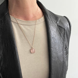 Karen Karch by Deme Wolfe Pink rose quartz pendant with rose gold frame with sharp claws on chain on person
