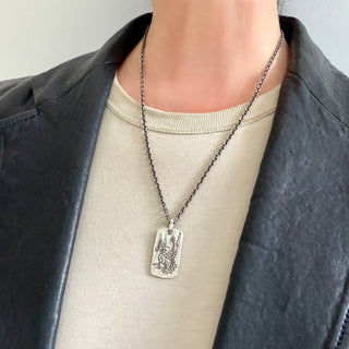 Karen Karch Silver Dragon Legend Tag with Vine Bail on chain on a person.