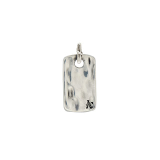 Back Side of a rectangular weathered dog tag on a textured bail with a crossing vine detail on a white background.
