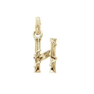 Karen Karch textured 10k yellow gold charm in the shape of the letter 'H' with a vine-detail and rectangular bail on white background.