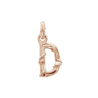 Karen Karch textured 10k rose gold charm in the shape of the letter 'D' with a vine-detail and rectangular bail on white background.