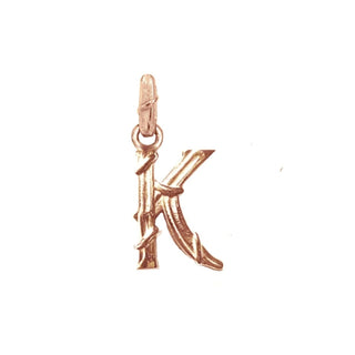 Karen Karch textured 10k rose gold charm in the shape of the letter 'K' with a vine-detail and rectangular bail on white background.