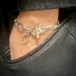 Karen Karch 10k yellow gold  Weathered Outshine Toggle and Oval Loop Clasp on Silver Oval Link Chain Adjustable length bracelet on wrist.