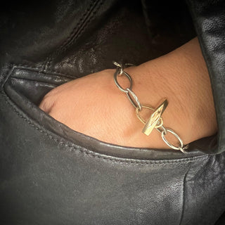 Karen Karch 10k yellow gold  Weathered Outshine Toggle and Oval Loop Clasp on Silver Oval Link Chain bracelet on wrist