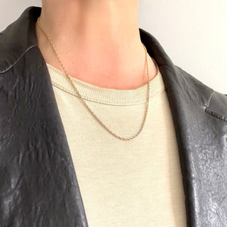 Person wearing a Karen Karch 1.8mm 14k yellow gold cable chain with oval shape links.